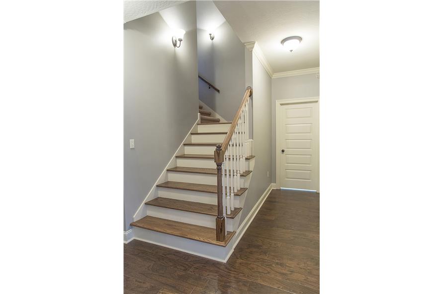 Entry from the garage with a staircase leading to the upstairs bonus room.