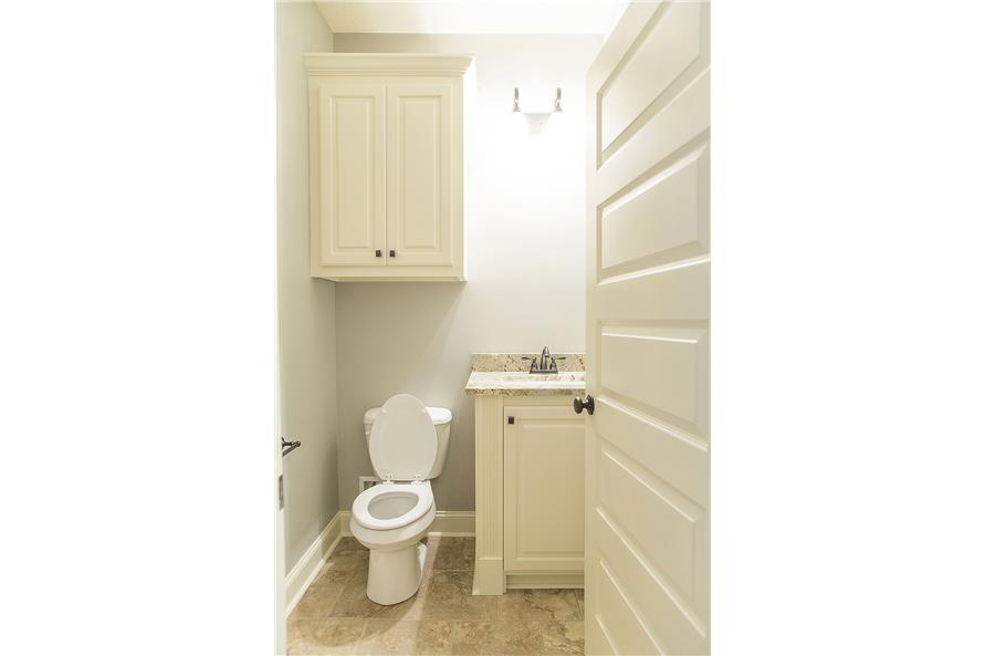 A glass sconce above the sink brightens the bathroom.