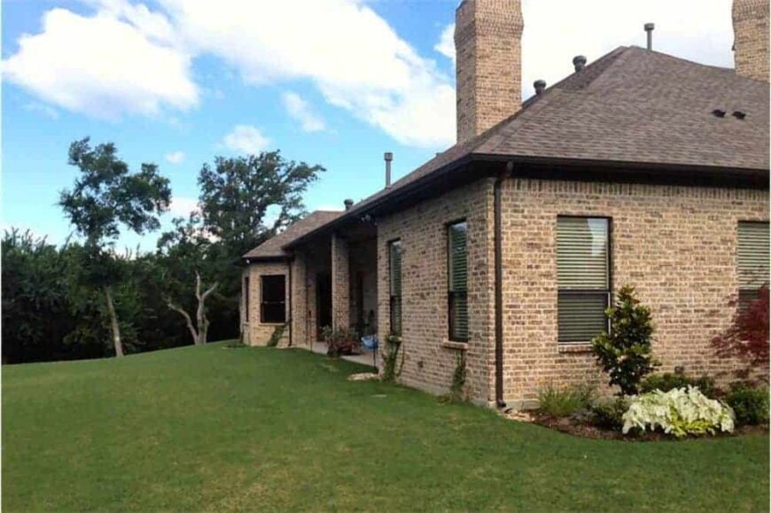 Rear exterior view showing the covered porch lined with brick columns.