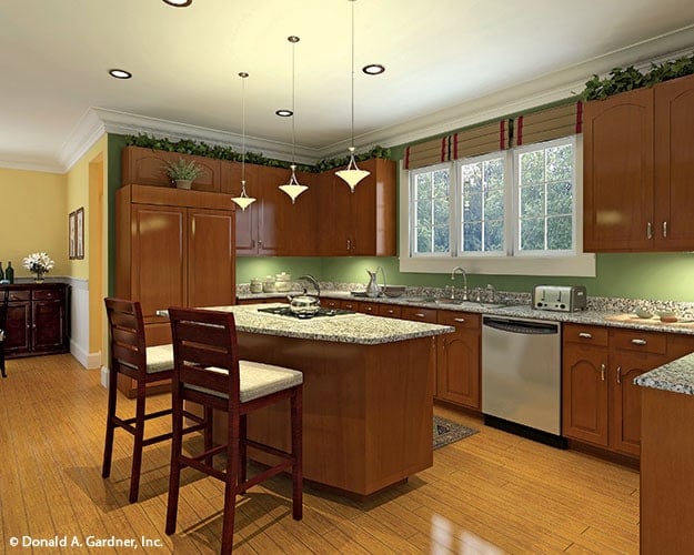 The kitchen is equipped with granite countertops, natural wood cabinetry, and a cooktop island.