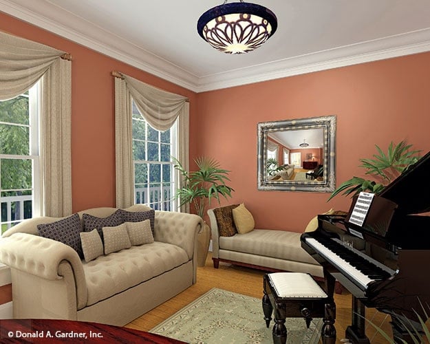 The sitting room is furnished with a chesterfield sofa, a lounge bench, and a baby grand piano.