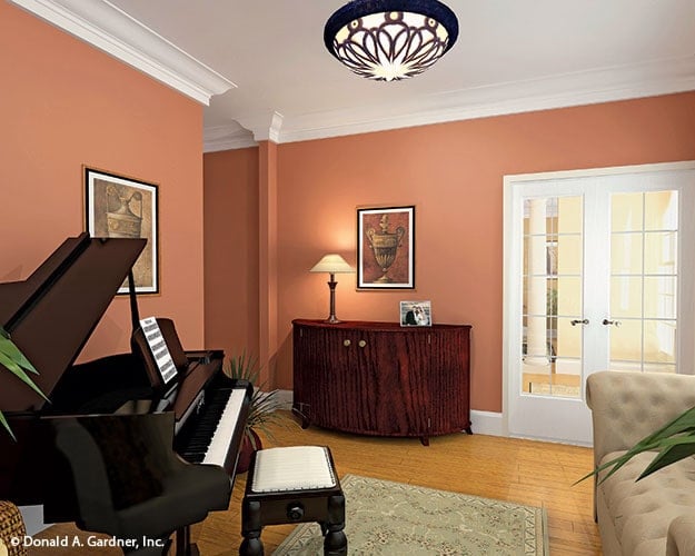 The sitting room includes a french door and a wooden console table adorned with a framed artwork.