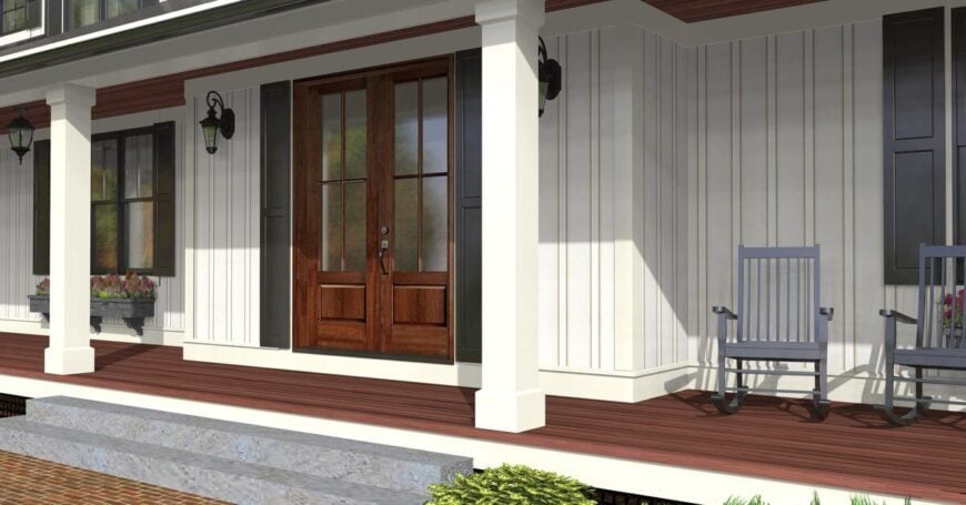 Covered porch with rocking chairs and a french entry door flanked by wall sconces.
