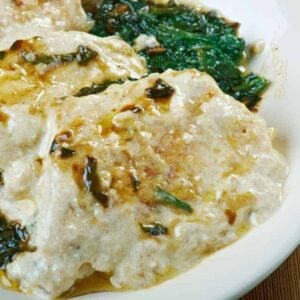 A close look at a plate of chicken florentine.