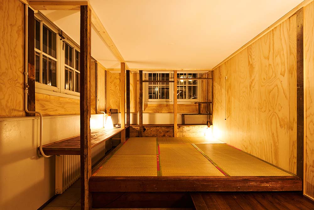 This is a nighttime view of the large open area with a platform in the middle showcasing the warm glow of the lights.
