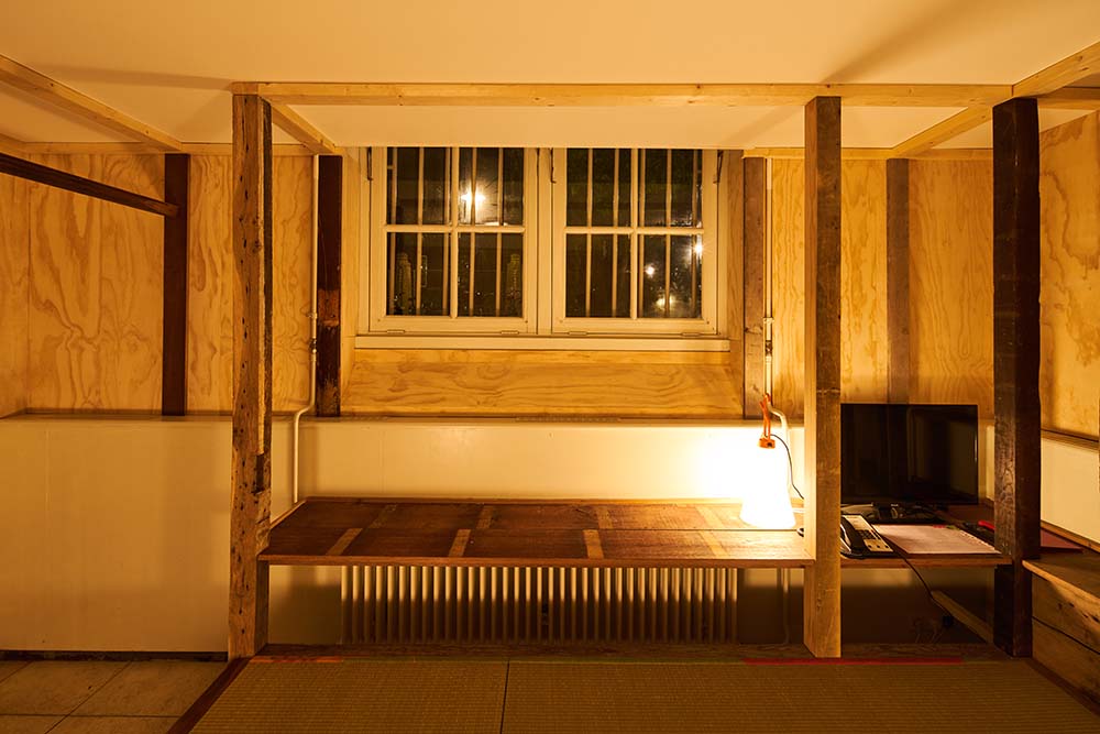This is a closer look at the built-in wooden structure on the side of the window for a table or bench.