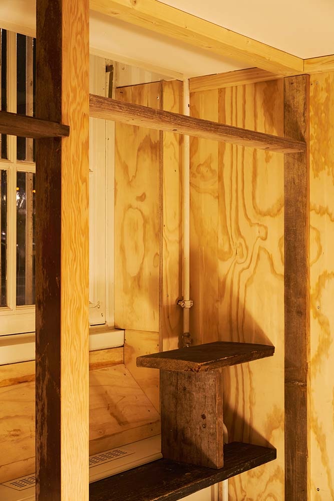 This is a close look at one of the thick wooden beams and pillars that support the area by the built-in shelf on the corner of the window.