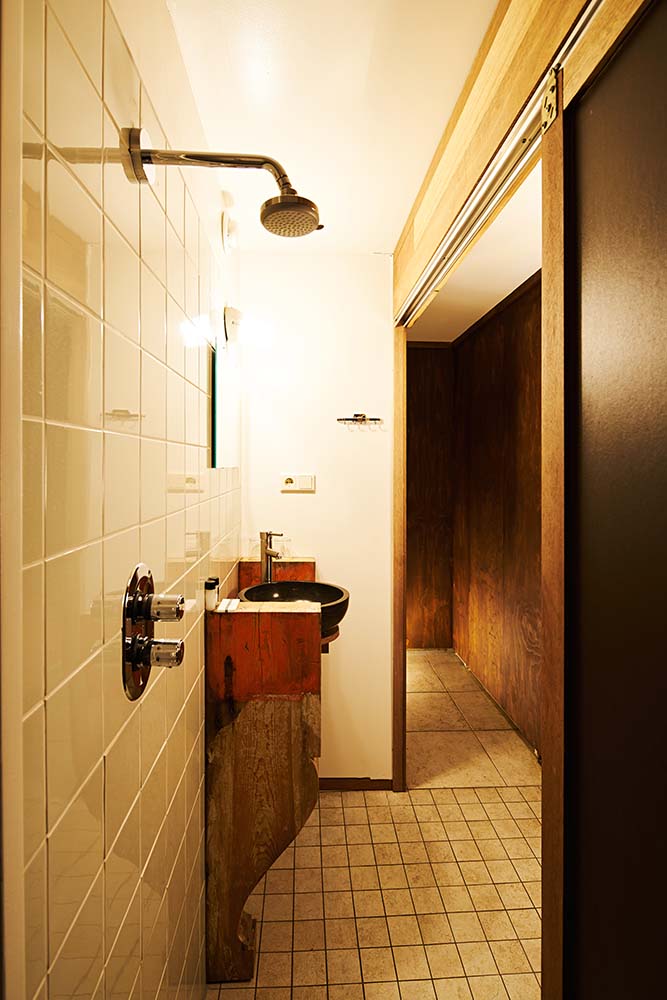 The bathroom vanity is complemented by the bright warm light above the mirror.