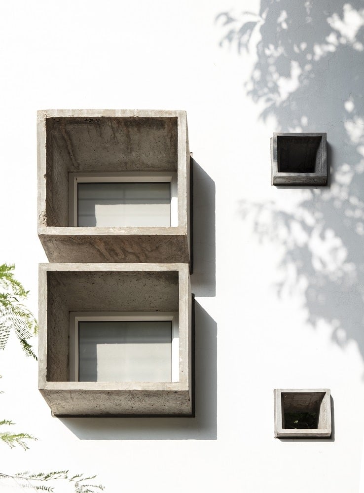This is a close look at a few windows with concrete structures making the windows stand out.