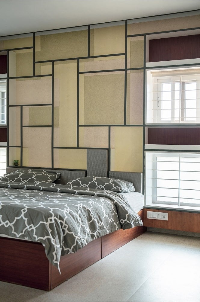 These elements of the bedroom are then brightened by the windows on the sides of the bed with shades to filter the natural lights.