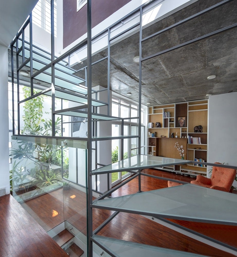 This is a closer look at the unique design of the staircase that has wrought iron railings and frosted glass steps
