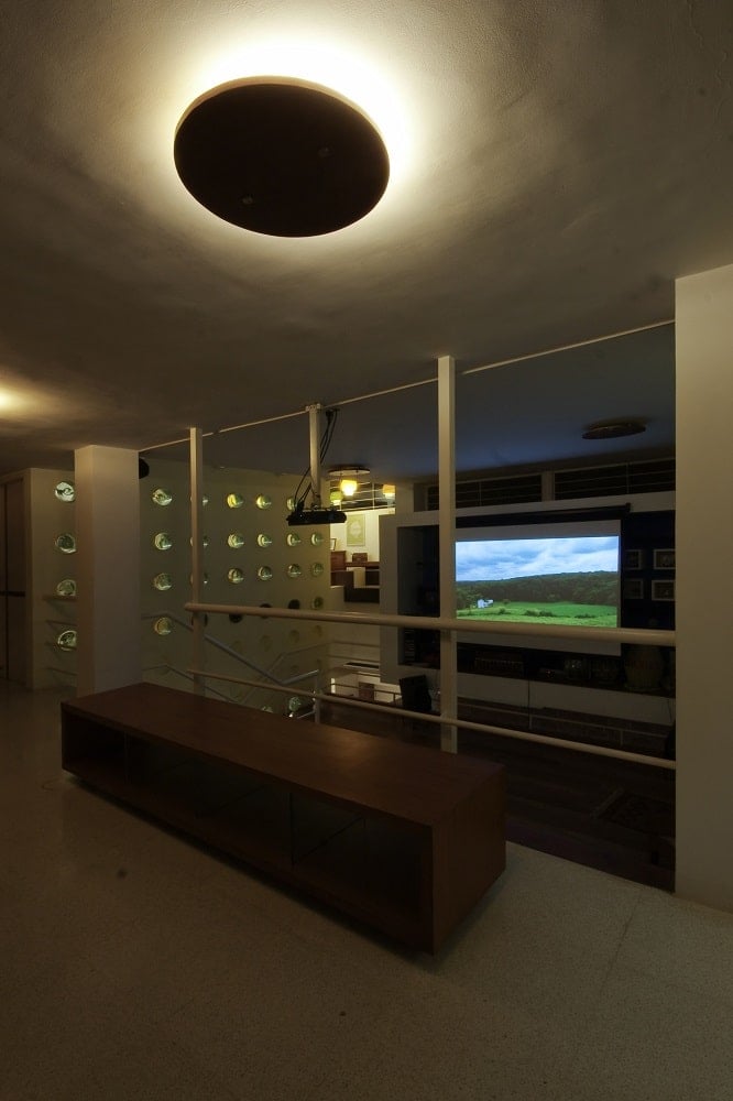 This is a view of the same landing with the lights off to showcase the projected screen on the lower level.