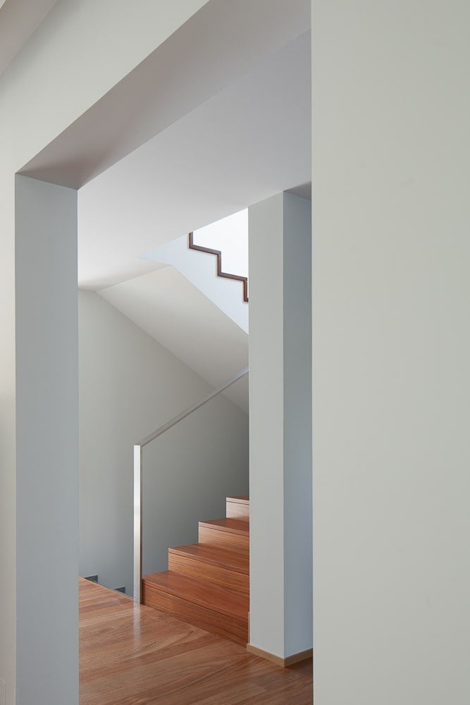 The staircase pairs well with the hardwood flooring and the stainless steel banisters.