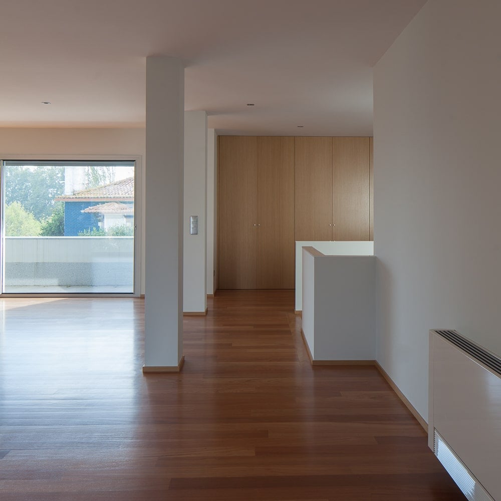 This is a close look at the staircase landing and entryway of the great room. You can also see the built-in wooden cabinets on the far wall.