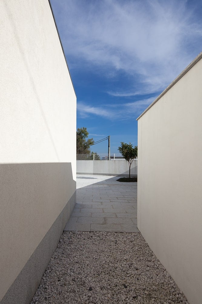 This is an outdoor hallway on the side of the house leading to the outdoor area of the living room.