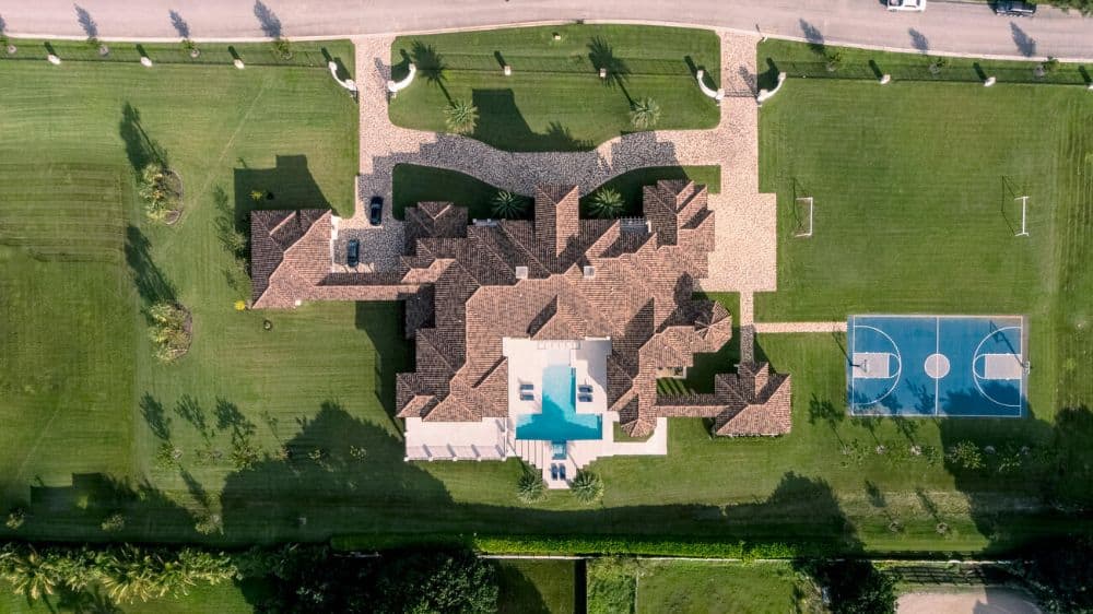 This is an aerial view of the house showcasing the brick driveways and walkways that match the earthy tones of the roof.