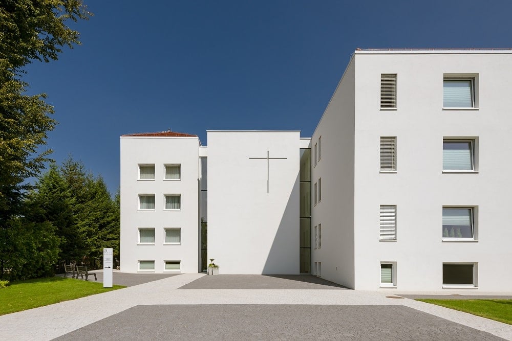 This is a close look at the main driveway with a gray and beige pattern that pairs well with the beige exteriors of the monastery.