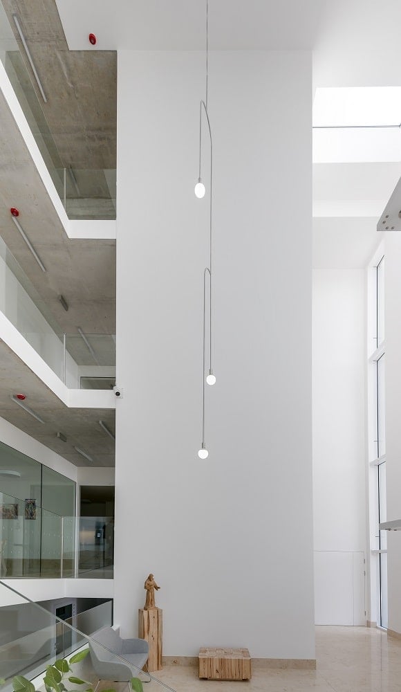 This is a view of the tall ceiling of the atrium with multiple indoor balconies on the different levels above.