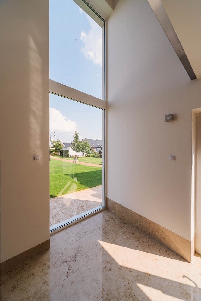 This is a far corner of the interior that has a large glass wall with a view of the landscape outside.