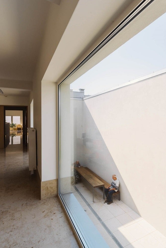 This is a view of the lower level courtyard from the vantage of the upper level window showcasing the sitting area.
