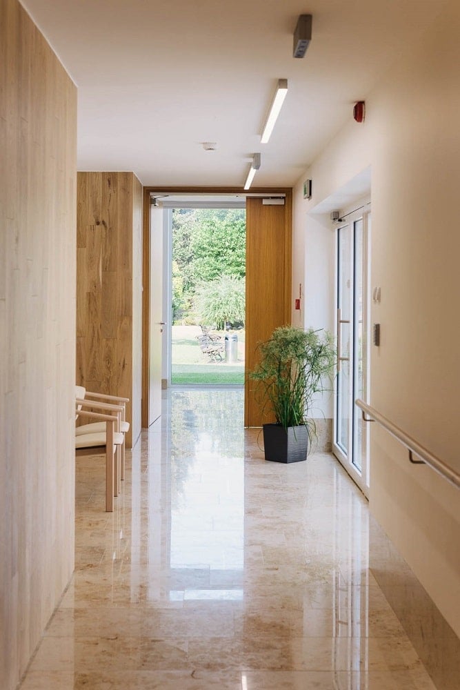 This is a hallway that leads to a door to access the exterior areas of the senior house.