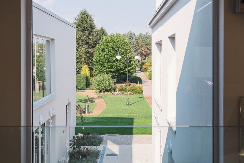 This is an upper level window that looks over the courtyard below flanked by tall walls.