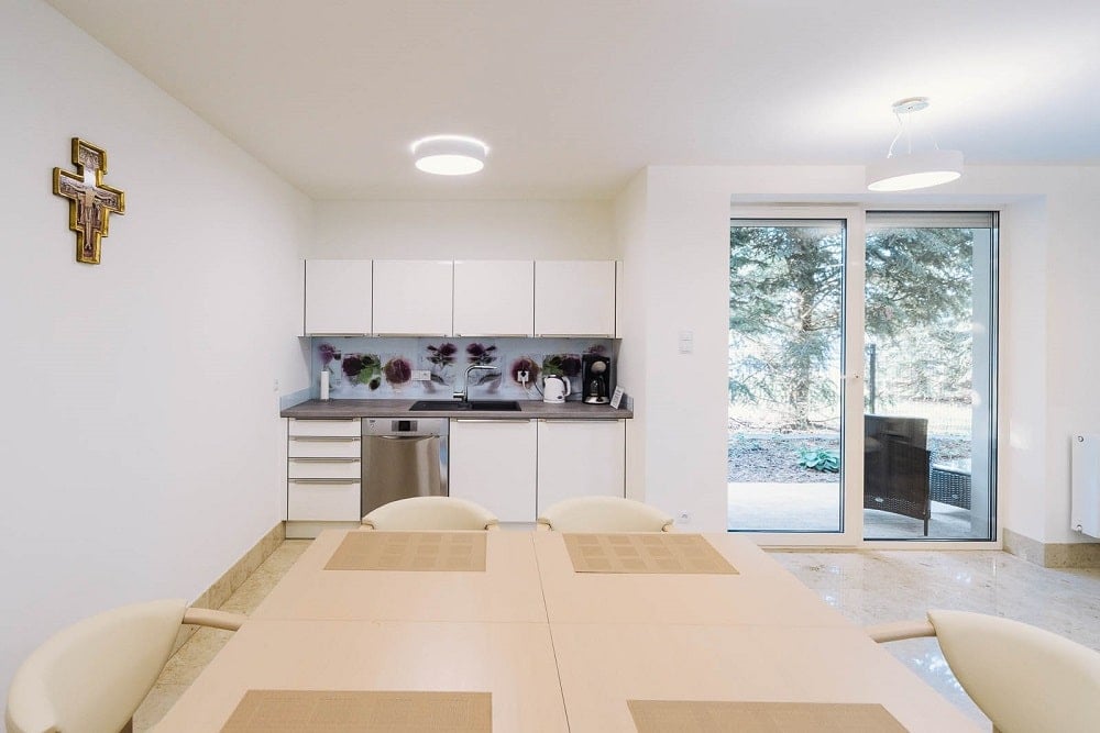 This is a close look at one of the room with its own kitchenette beside the glass doors.
