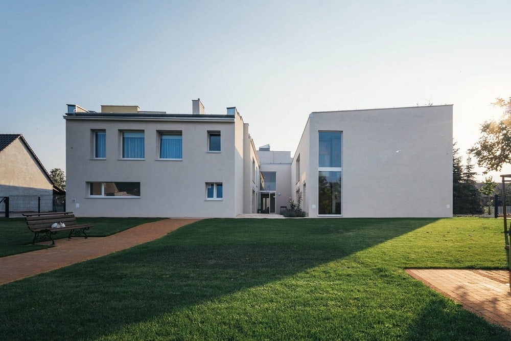 This is a view of the large grass lawn with walkways and a view of the senior house exteriors.