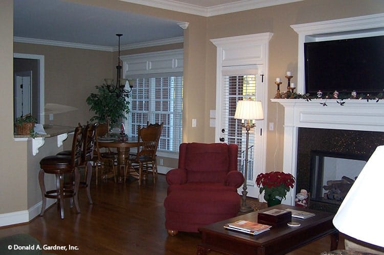 An open layout view showing the living room, dining area, and kitchen with an eating bar.