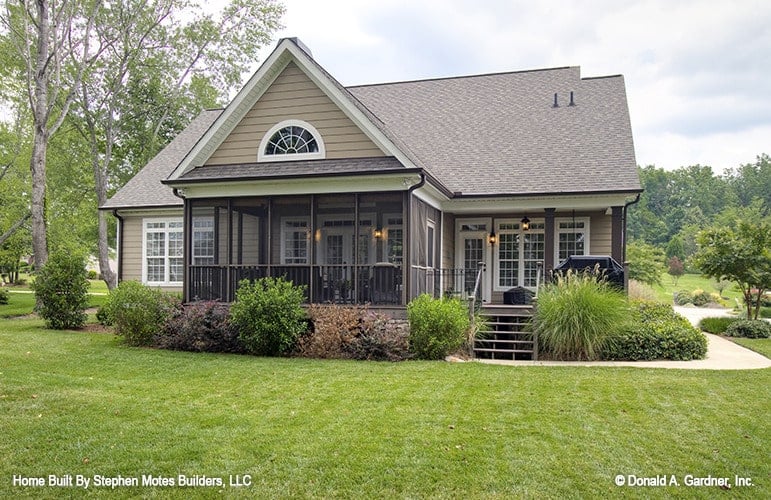 Rear exterior view with a screened porch and a covered deck framed with dark wood pillars.