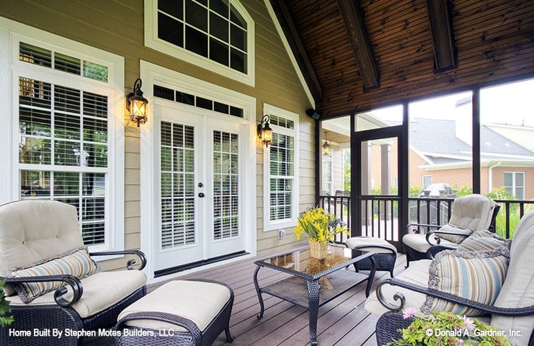 A white french door off the screened porch leads to the great room.