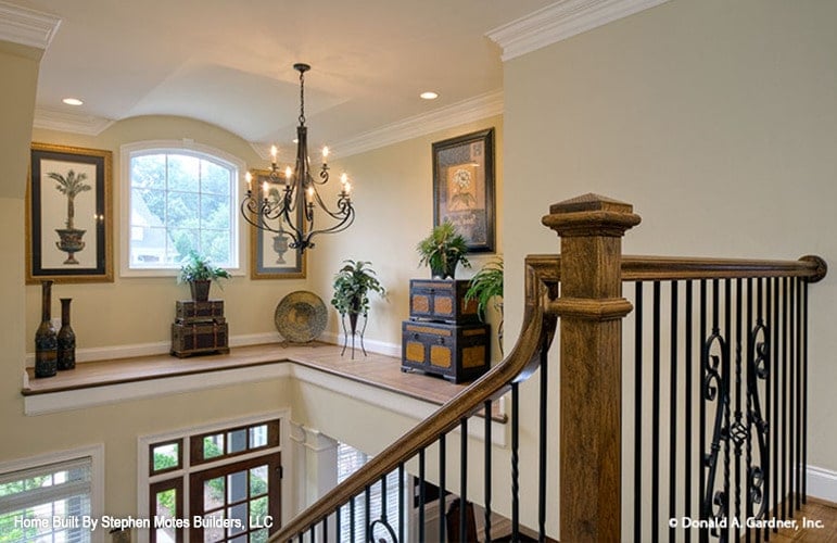 Balcony loft with vases, trunk chests, and framed artworks.