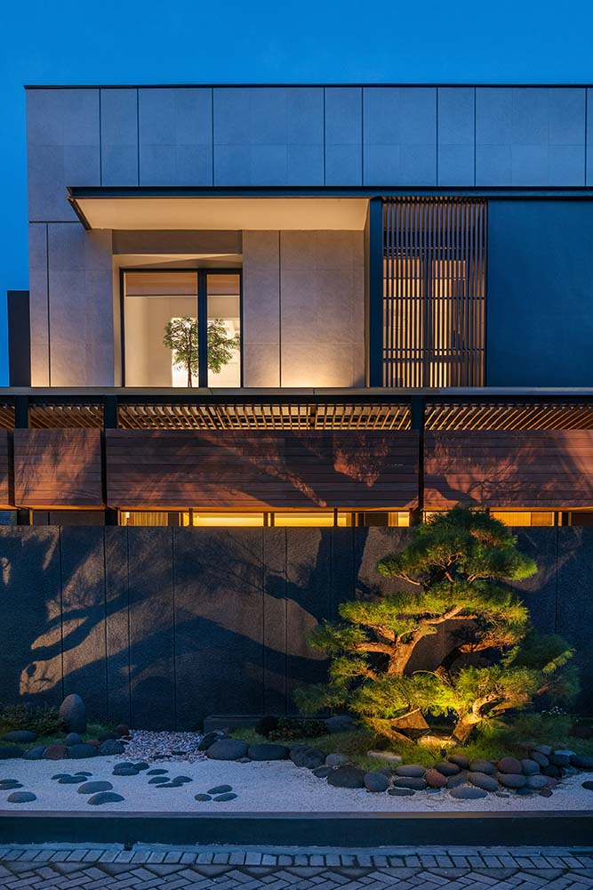 The slatted wooden panels of the house exterior also transform at night with the interior lights escaping through the slats.