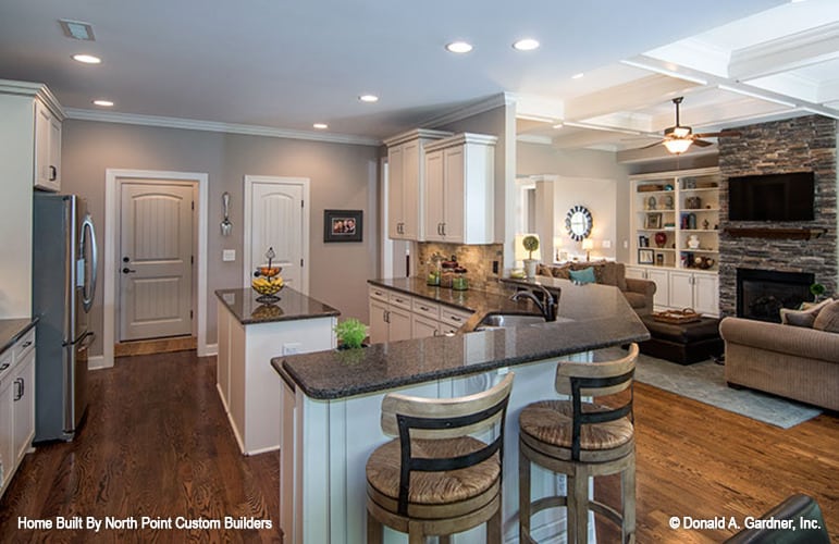 A curved peninsula separates the kitchen from the living area.