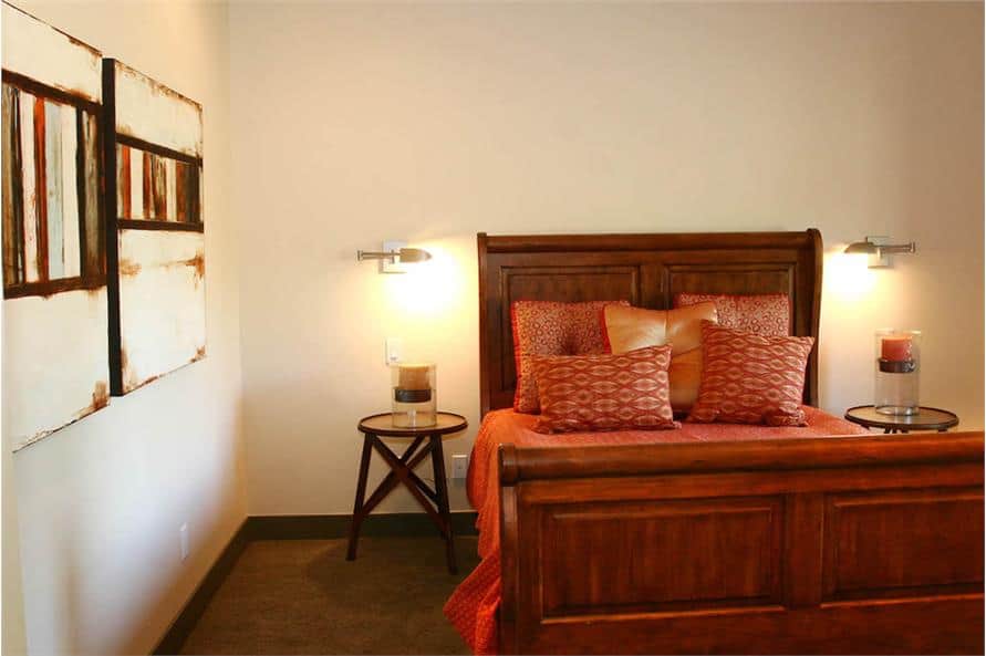 This bedroom features a wooden bed flanked by round nightstands.