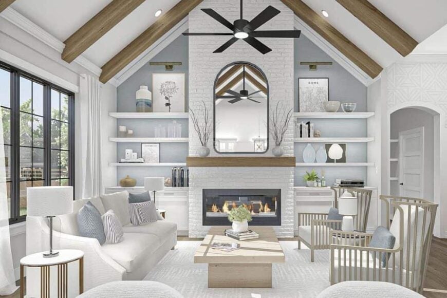 The living room features a white brick fireplace and a cathedral ceiling lined with exposed wood beams.
