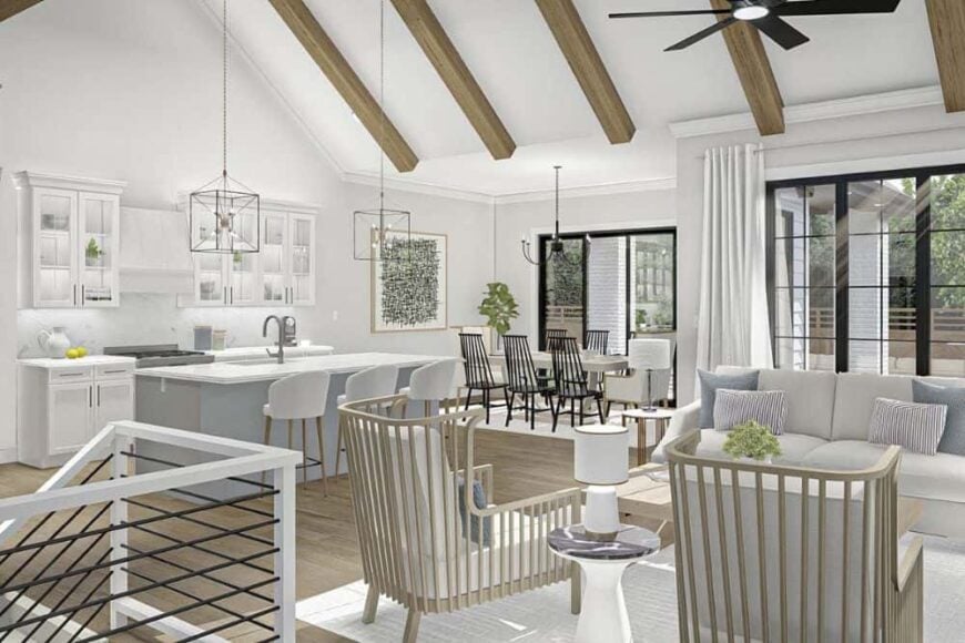 An open layout view showing the living room, dining area, and kitchen under a vaulted ceiling.