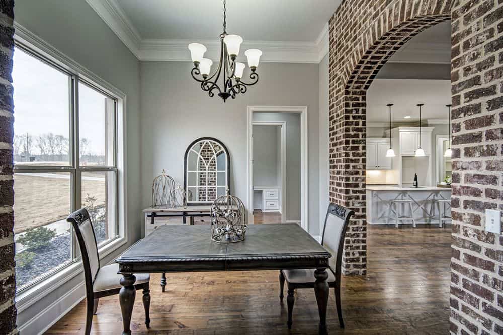 The dining room offers a wooden dining set and a buffet table topped with an arched mirror.