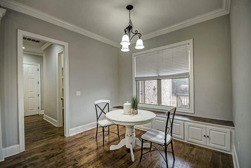 Breakfast area with a round dining set and a window seat nook.