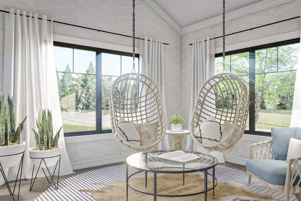Sunroom with a couple of swings, a cushioned armchair, and a round glass top table over a cowhide rug.