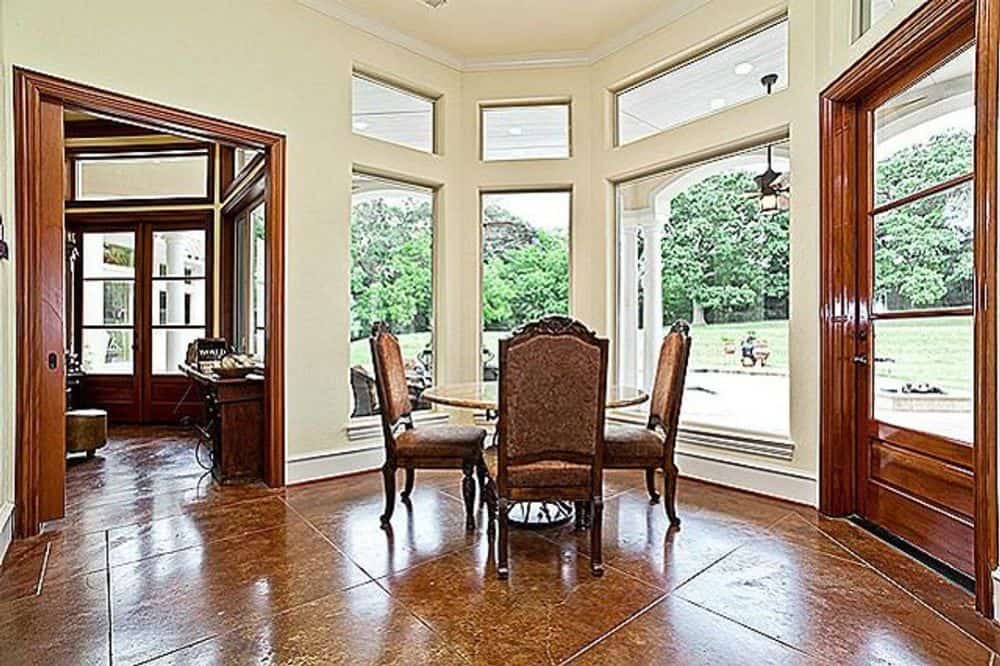 Breakfast nook with a round dining set and a bay window that brings natural light in.