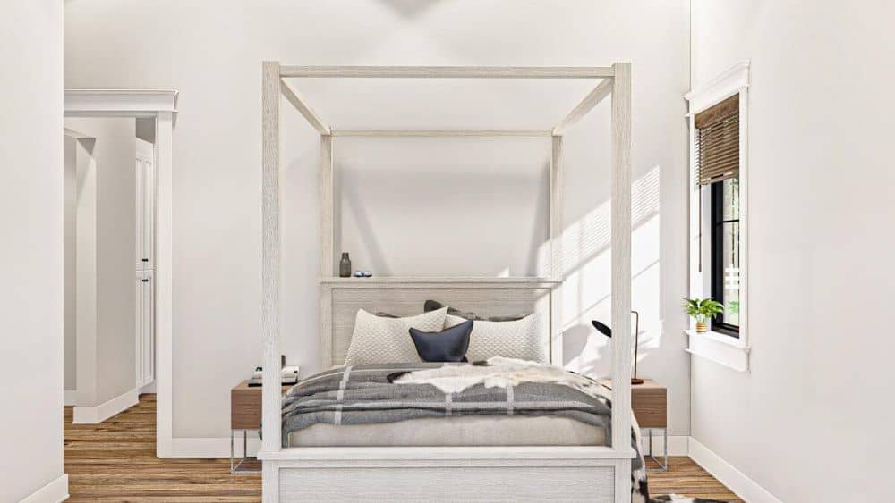 Primary bedroom with a canopy bed flanked by wooden nightstands.