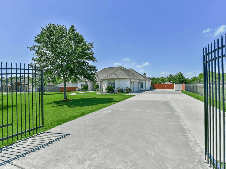 The home is enclosed in wrought iron gates.