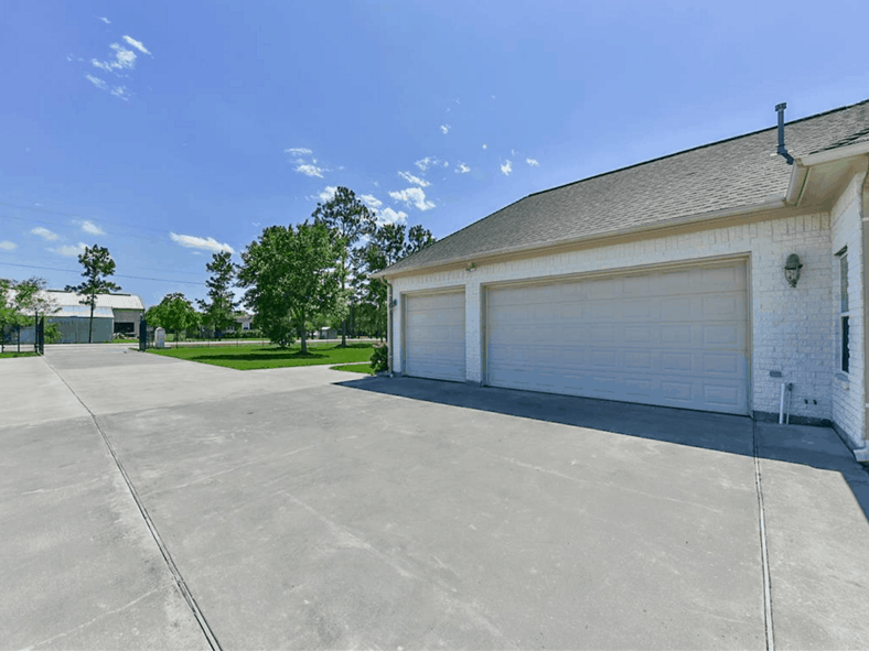 A closer look at the garage with oversized paneled garage doors.