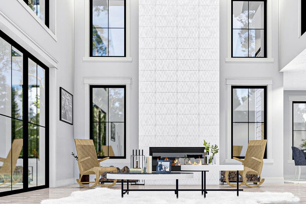 Living room with a two-story ceiling, wooden rockers, a modular coffee table, and a modern fireplace.