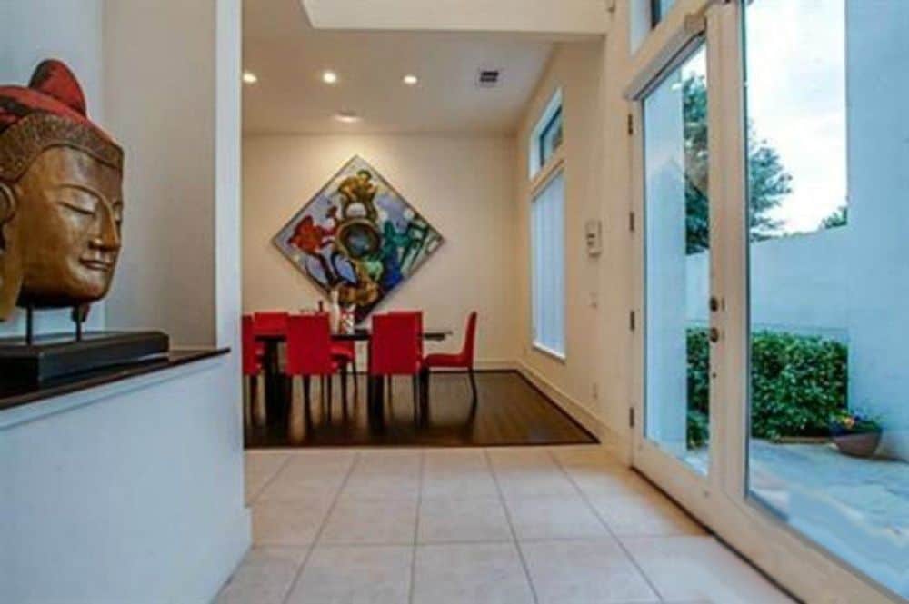 Foyer with a glazed entry door and a wall niche filled with contemporary decors.