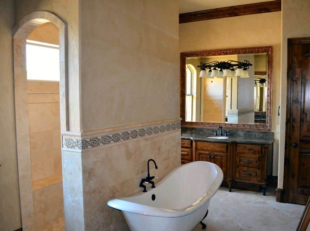 Primary bathroom with a sink vanity, a clawfoot tub, and a walk-in shower.