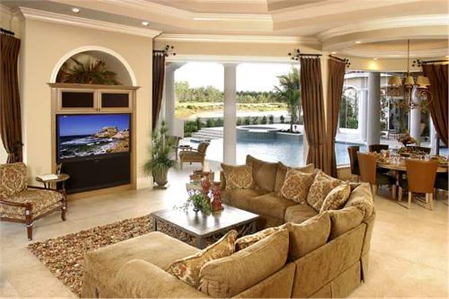 The family room offers a U-shaped sectional and a TV placed against the arched inset wall.