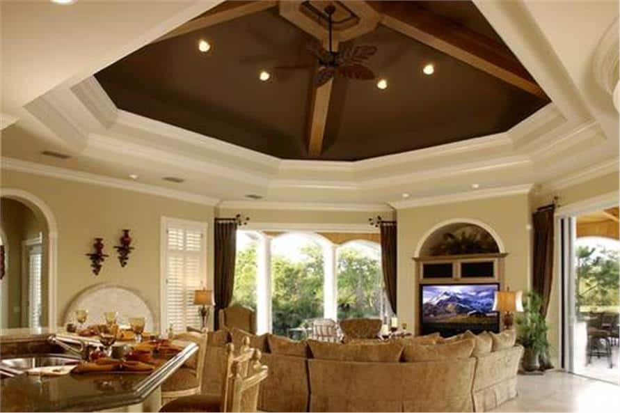 A stunning tray ceiling with decorative beams crowns the family room.