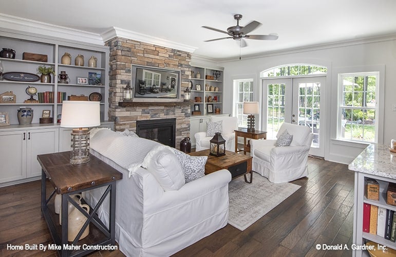 Glass doors and windows on the side bathe the great room with natural light.